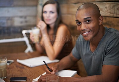Buy stock photo Portrait of two young friends studying together at a coffee shop