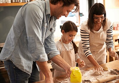 Buy stock photo Shot of a young family having fun baking in a kitchen