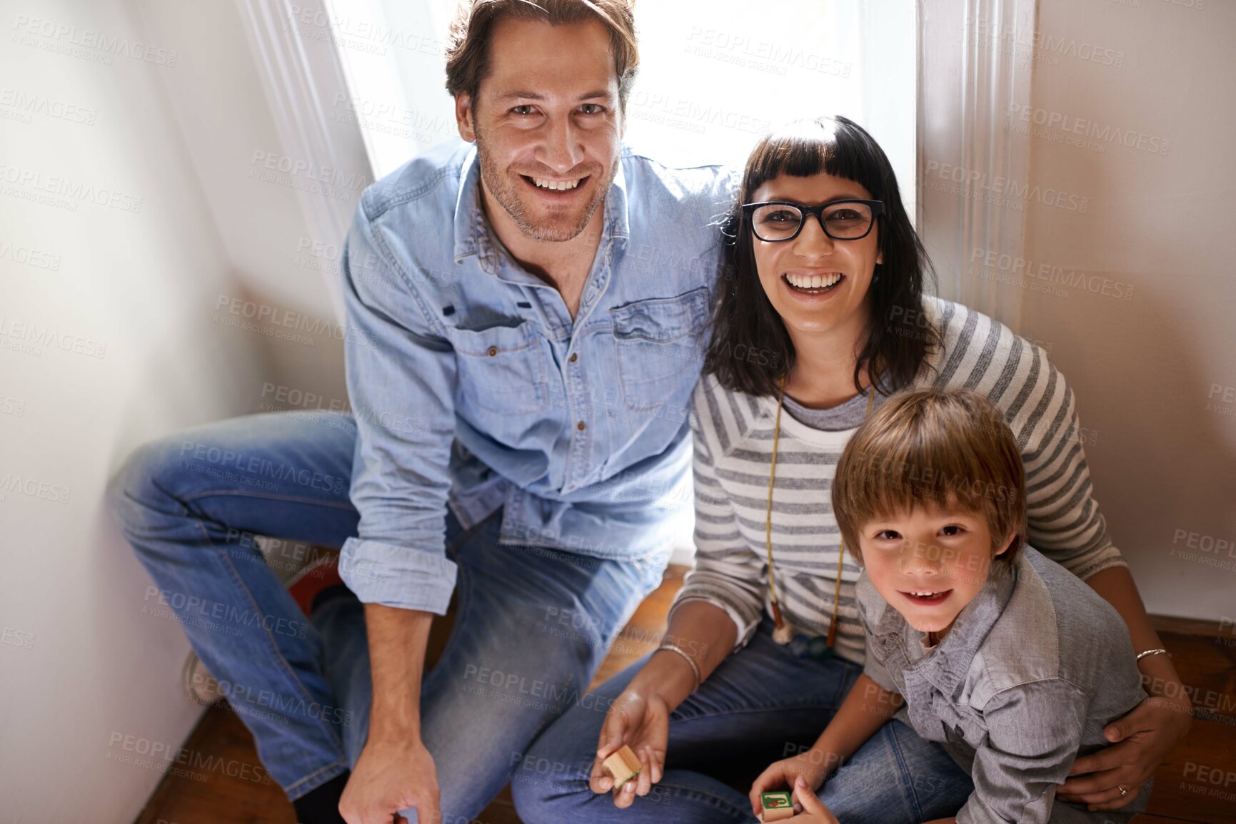 Buy stock photo A mother and father sitting with their son