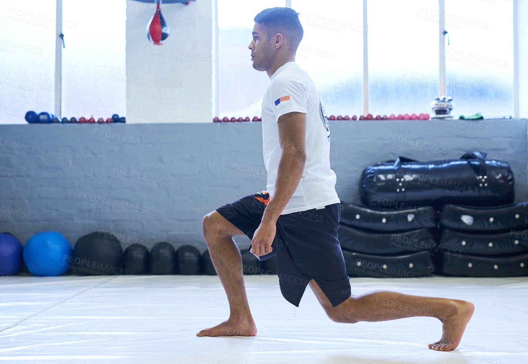 Buy stock photo Shot of a young man going through his workout routine