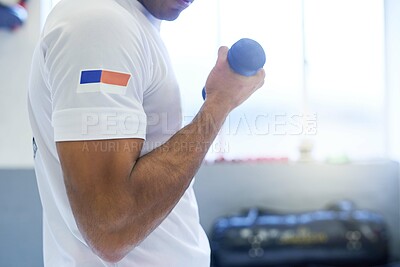 Buy stock photo Shot of an unrecognizable man going through his workout routine in the gym