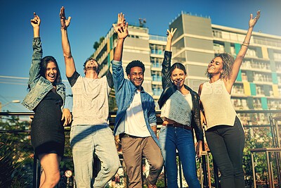 Buy stock photo Cropped shot of a group of young diverse friends spending the day outside on a rooftop