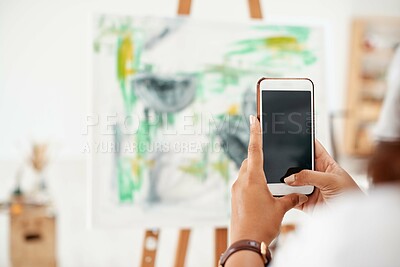 Buy stock photo Cropped shot of an unrecognizable artist standing and taking a picture of her artwork with her cellphone in the studio