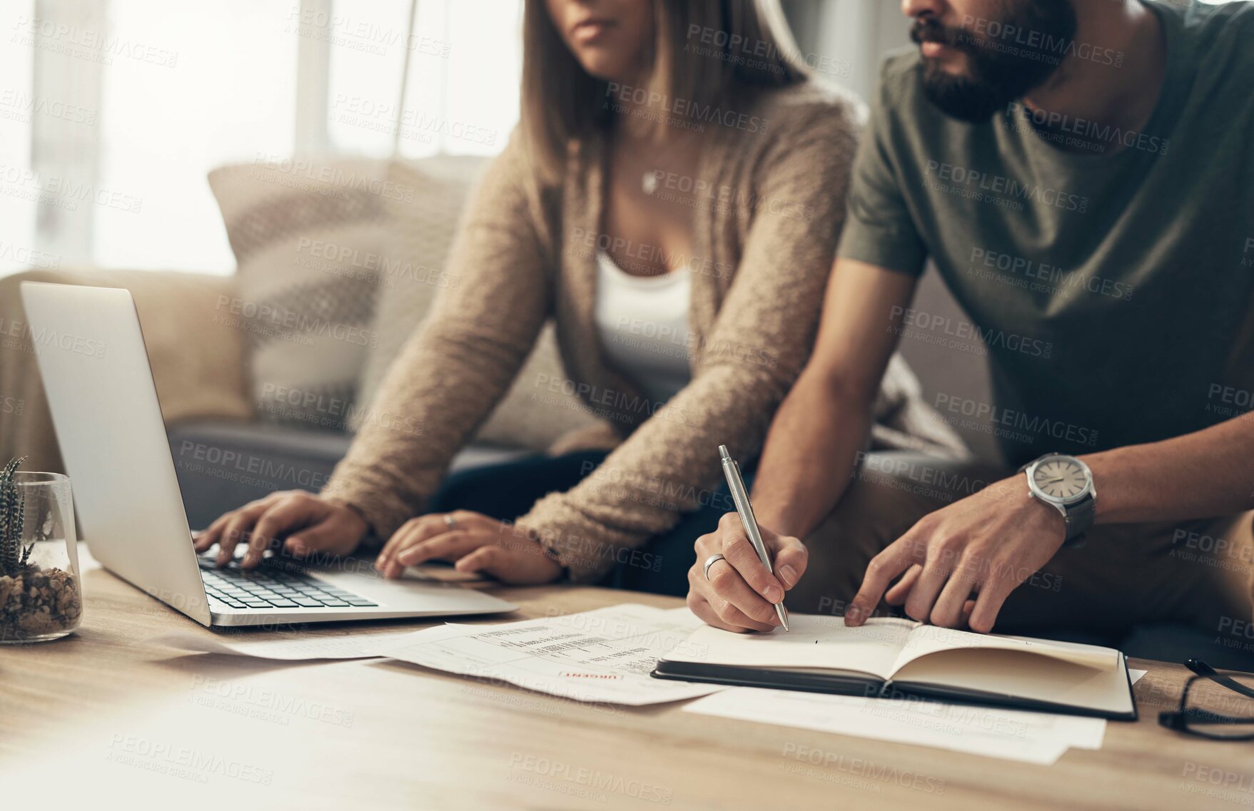 Buy stock photo Cropped shot of a couple going over paperwork at home