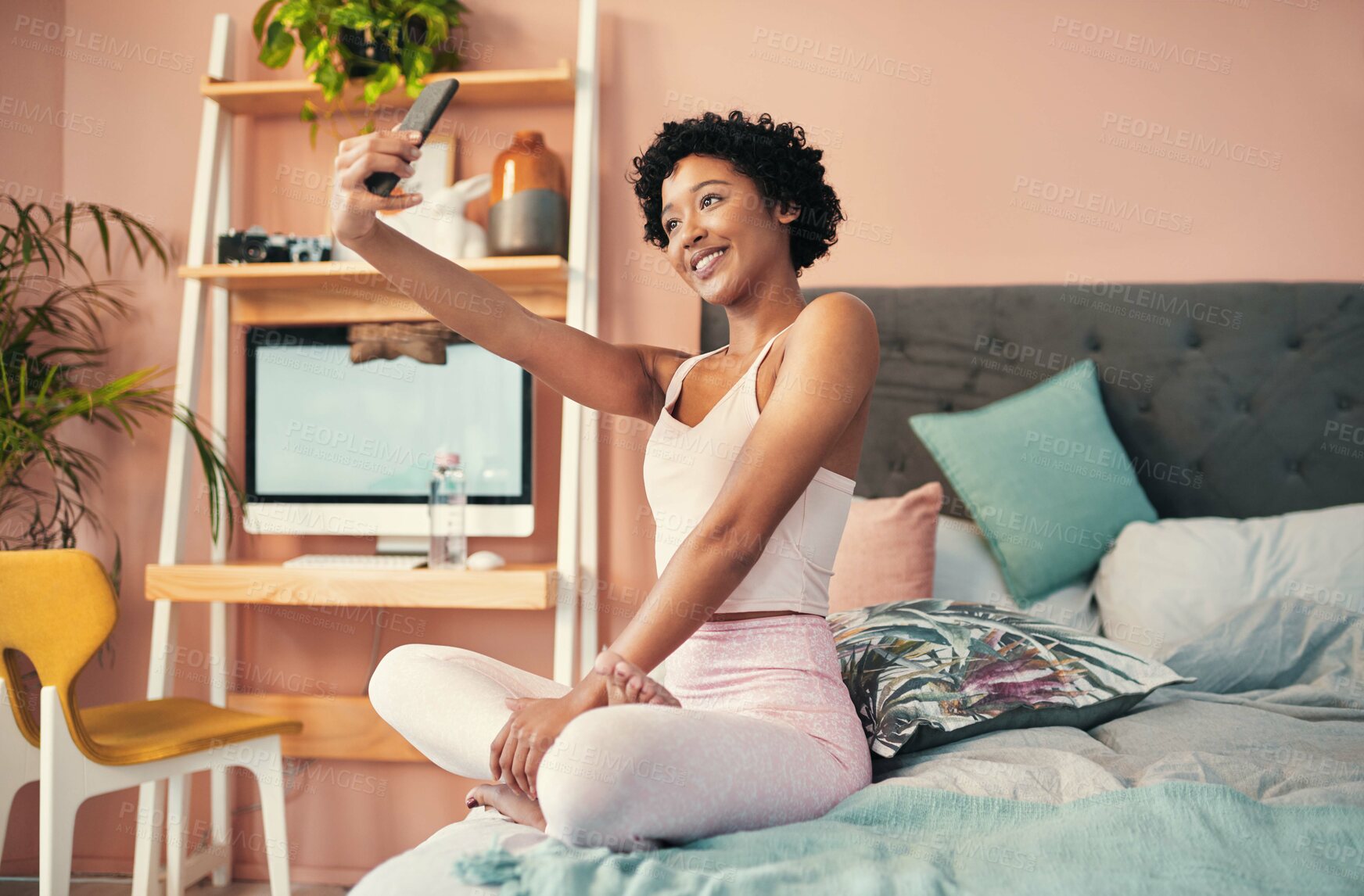 Buy stock photo Shot of a young woman taking selfies at home