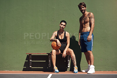 Buy stock photo Portrait of two sporty young people taking a break after a game of basketball