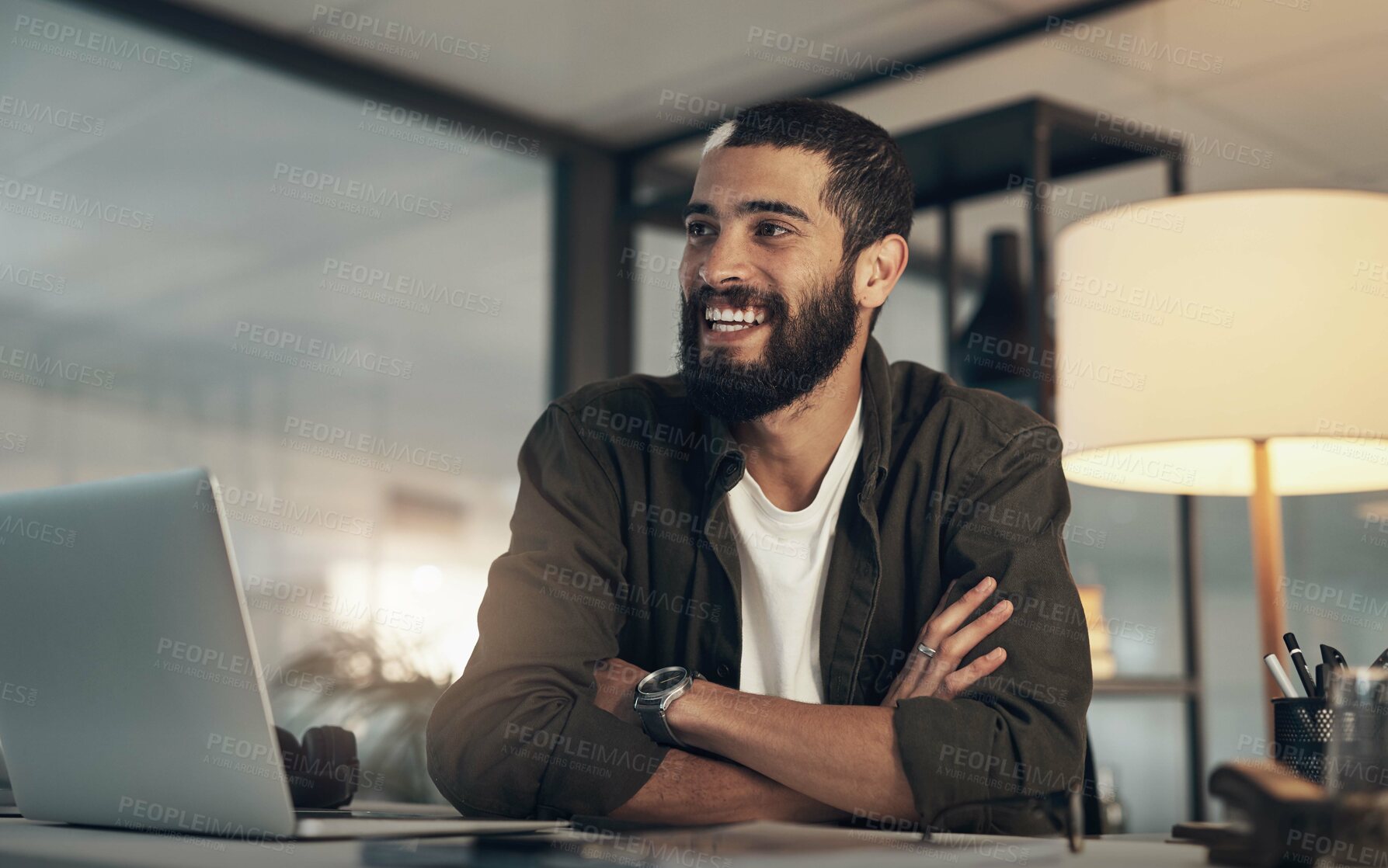 Buy stock photo Shot of a young businessman using a laptop during a late night at work