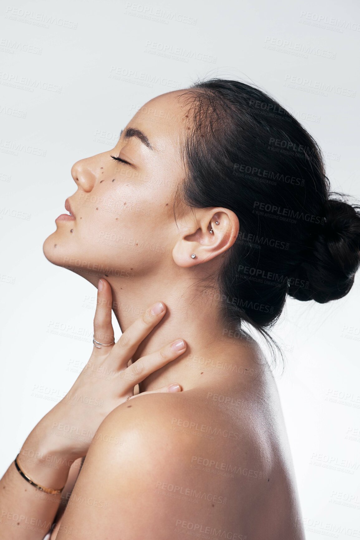 Buy stock photo Cropped shot of a beautiful young woman posing against a white background