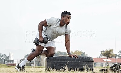 Buy stock photo Shot of a masculine young man working out with a dumbbell