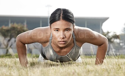 Buy stock photo Shot of a beautiful young woman doing push-ups outside