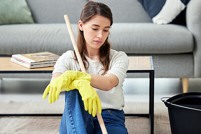 Buy stock photo Cleaning, burnout and an unhappy woman in the living room of her home for housework chores. Sad, tired or exhausted with a young person looking bored in her apartment for housekeeping responsibility