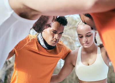 Buy stock photo Shot of a diverse group of friends standing huddled together after their workout