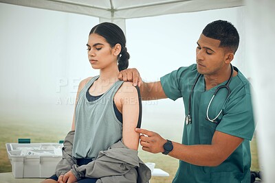 Buy stock photo Cropped shot of a handsome young male physiotherapist working on a female patient outside