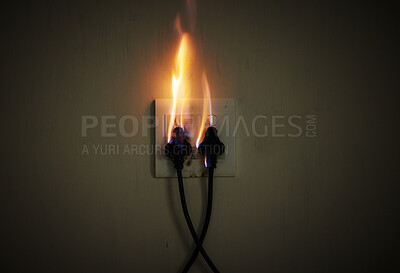 Wall, cables and electrical fire on a plug socket in studio on a dark background for safety. Danger, smoke and power with risk of flame on an outlet for electricity in the circuit of a home closeup