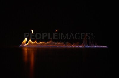 Buy stock photo Flame, heat and gas fire with black background with sparks, smoke and light from burning in studio. Fuel, flare and glow from thermal power and art in the dark with creativity and inferno with burn