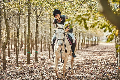 Happy woman on horse, riding in forest and running practice for competition, race or dressage with trees. Equestrian sport, female jockey or rider on animal in woods for adventure, training and smile