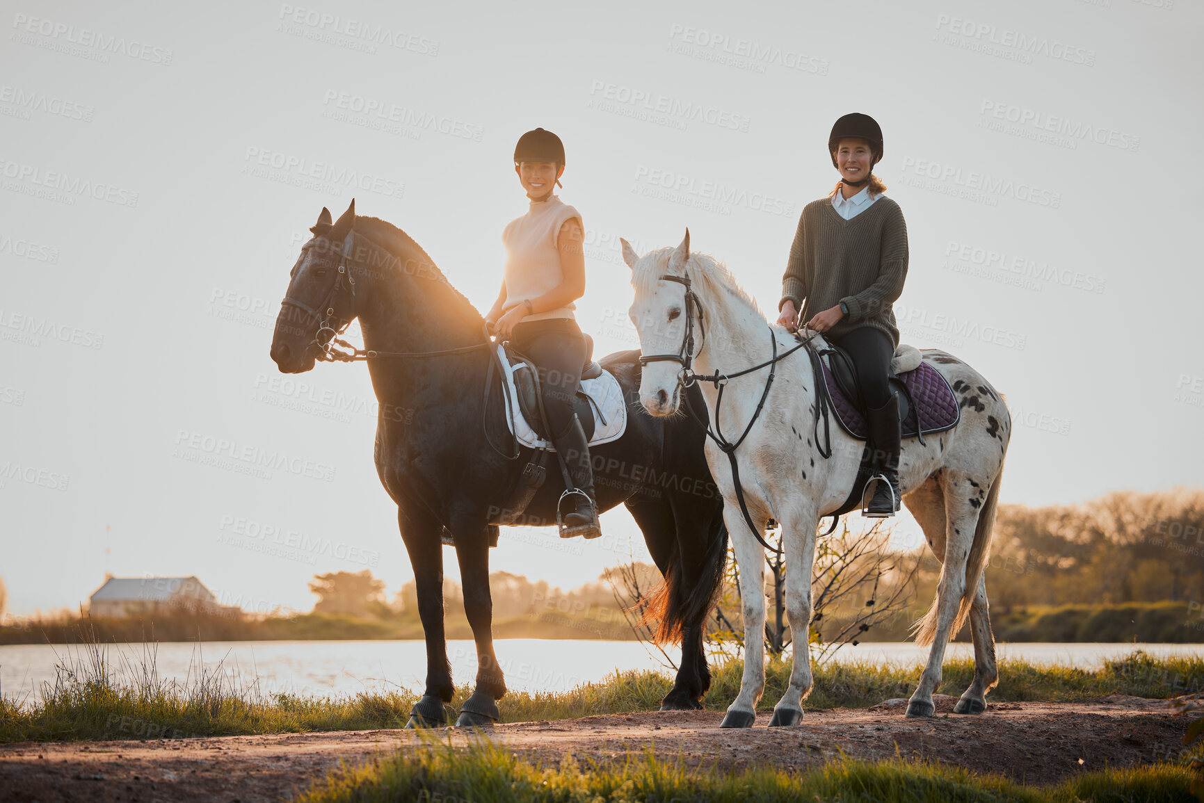 Buy stock photo Horse riding, sunset and hobby with friends in nature on horseback by the lake during a summer morning. Countryside, equestrian and female riders outdoor together for travel, hobby or adventure