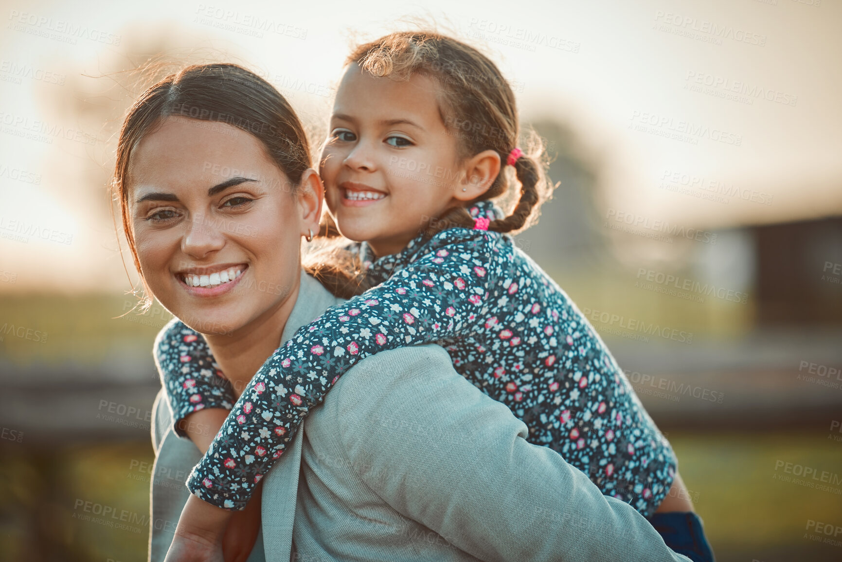 Buy stock photo Mother, happy girl and portrait of piggy back fun and parent care outdoor in equestrian field. Mom smile, child happiness and family in nature with blurred background in summer on holiday in a park