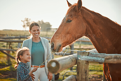 Horse feeding, girl and mother on farm with animal and smile in the countryside outdoor. Pet horses, mama and child with hand holding grass on agriculture field with mom feeling parent love on ranch
