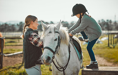 Child, horse and learning during a lesson with a woman about horseback riding with help on a farm. Helping, support and coach teaching girl kid with animal for sports physical activity in countryside