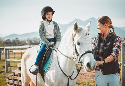 Happy child on horse, woman with harness on ranch and mountain in background lady and animal walking on field. Countryside lifestyle, rural nature and farm animals, mom girl kid to ride pony in USA.