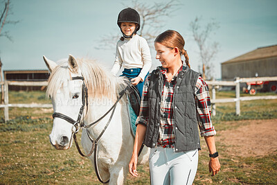 Woman, child on horse and happy ranch lifestyle and animal walking on field with girl, mother and smile. Countryside, rural nature and farm animals, mom teaching and helping kid to ride pony in USA.