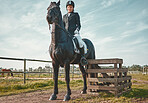 Sports, horse and equestrian with a woman jockey riding outdoor on a farm or ranch for horseback training. Nature, agriculture and field with a female athlete or rider on an animal for horesriding