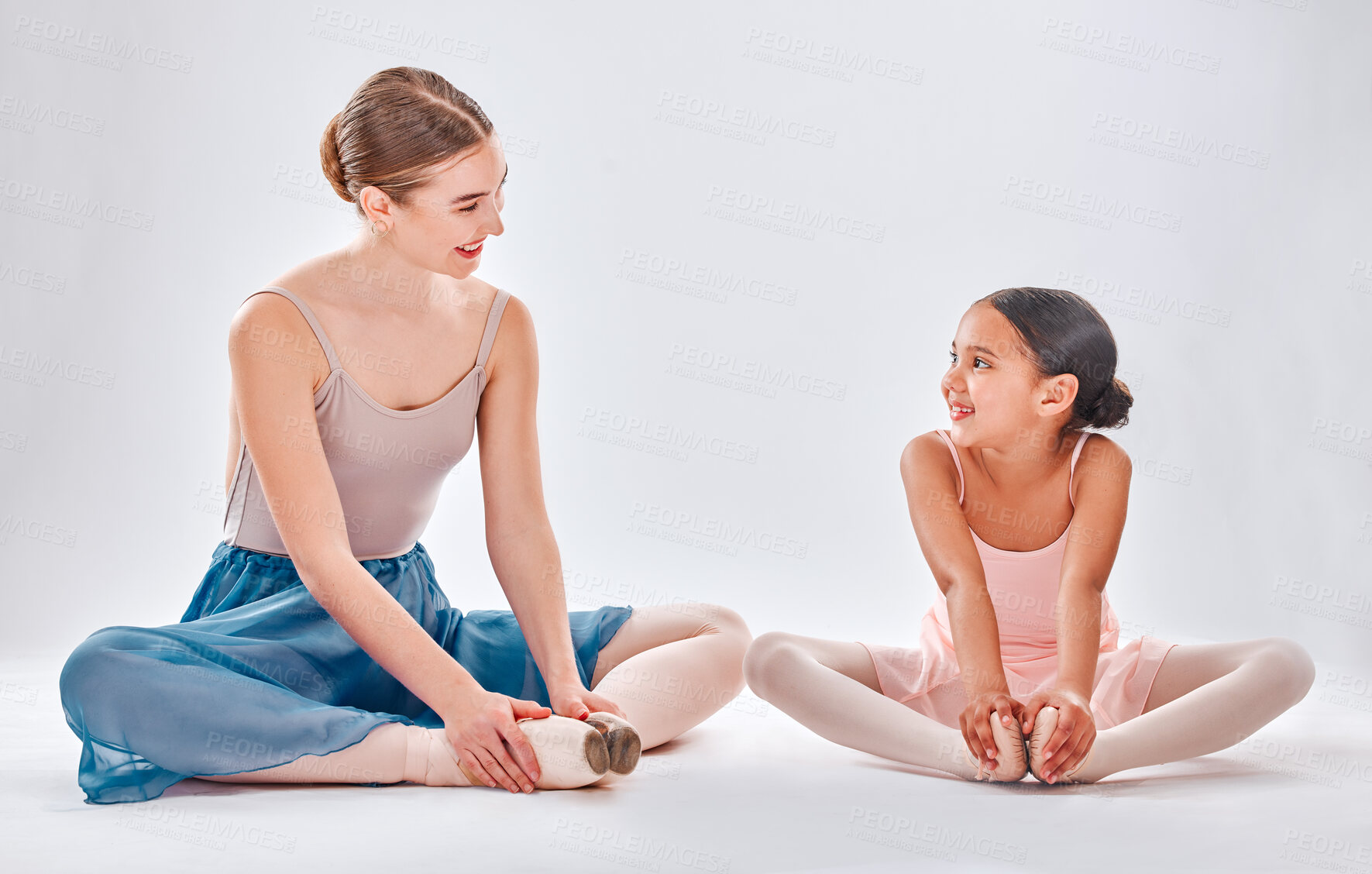 Buy stock photo Ballet, mentor and girl stretching, training and conversation for routine, happiness and studio. Ballerina, trainer and student with smile, support and talking for performance and child development