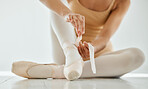 Woman, ballet shoes and tying for performance, dancer and prepare in dance studio, legs and ribbons. Female person, ballerina and ready for practice, competition and recital, artist and art academy