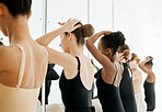 Women, mirror and fixing hair of dancer, ballerina and back for performance, prepare for competition. People, reflection and artist of ballet, haircare and beauty or wellness, friends and support