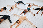 Ballet, students and leg stretching floor together for balance, exercise and flexibility training class from above. Art, dance studio and wellness, people stretch for fitness and creative dancing.