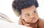 Thinking, african and a baby on a bed in the home for growth, curiosity or child development. Face, idea and afro with an adorable little infant in the bedroom of an apartment on a summer morning