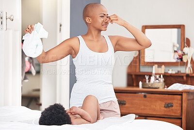 Buy stock photo Dirty diaper, smell and mother cleaning baby on a bed with nose pinch, gross or disgust in their home, Black family, love and black woman with kid in a bedroom for stink napkin, change or infant care