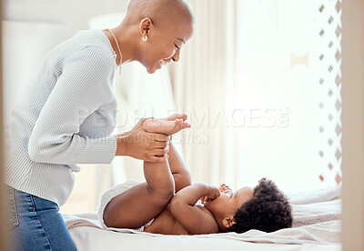Buy stock photo Baby, diaper and changing with a mother in the bedroom of their home for cleaning or care. Black family, children and an infant child on the bed for a nappy change with a woman parent for development