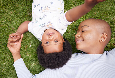 Buy stock photo Mother, calm and child on grass with black family, love and support together with baby in garden. Lawn, above and mom with happy kid, care smile and backyard with African mama and relax in nature