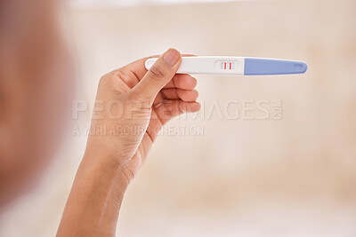 Buy stock photo Closeup, hands and holding of pregnancy test in home for family planning, ivf treatment or future. Person, maternity care and fertility stick with positive, pregnant and result in bedroom with kit