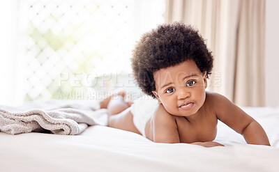Buy stock photo Portrait, african and a baby on a bed in the home for growth, curiosity or child development. Face, kids and afro with an adorable little infant in the bedroom of an apartment on a summer morning