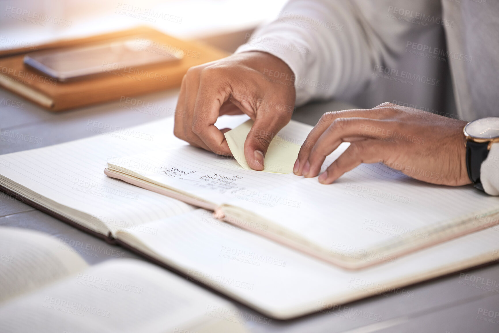 Buy stock photo Hands, closeup and sticky note with book on desk for reading, studying and knowledge with planning for analysis. Person, reminder and notebook on table for schedule, project management and process