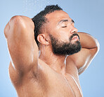 Shower, cleaning splash and relax man with shampoo and calm from water, skincare and morning routine. Bathroom, cosmetics and model in studio with blue background and dermatology for wellness wash