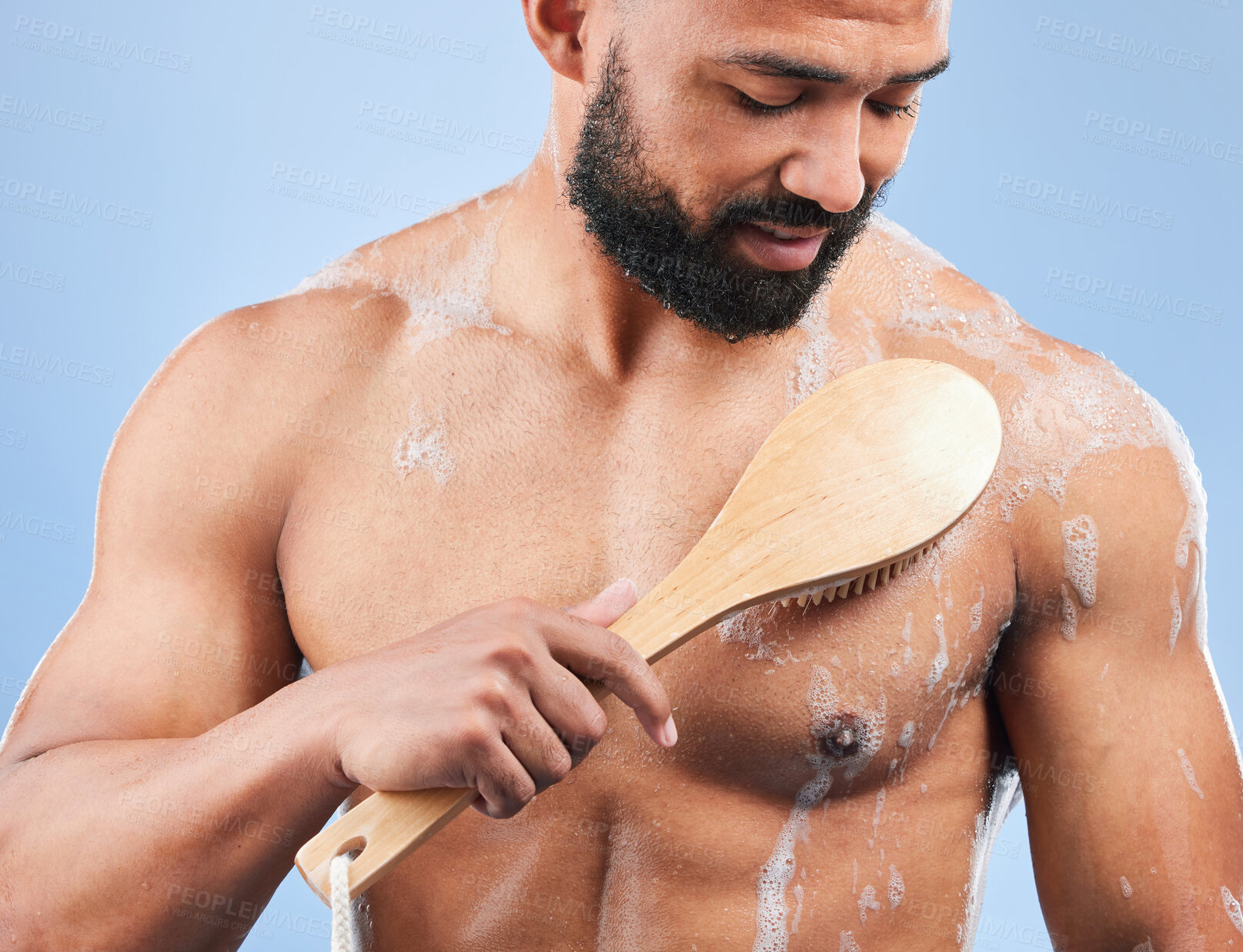 Buy stock photo Man, shower and brush for cleaning in studio with armpit, scrub and thinking for hygiene by blue background. Person, guy and foam for spa, cosmetics and wellness for body, skincare and healthy