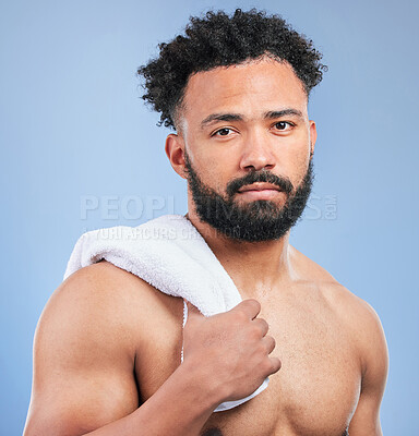 Buy stock photo Shower towel, grooming portrait and man in morning routine, facial beauty cleaning or self care maintenance. Bathroom, face wash and studio model hygiene, fresh bath and skincare on blue background