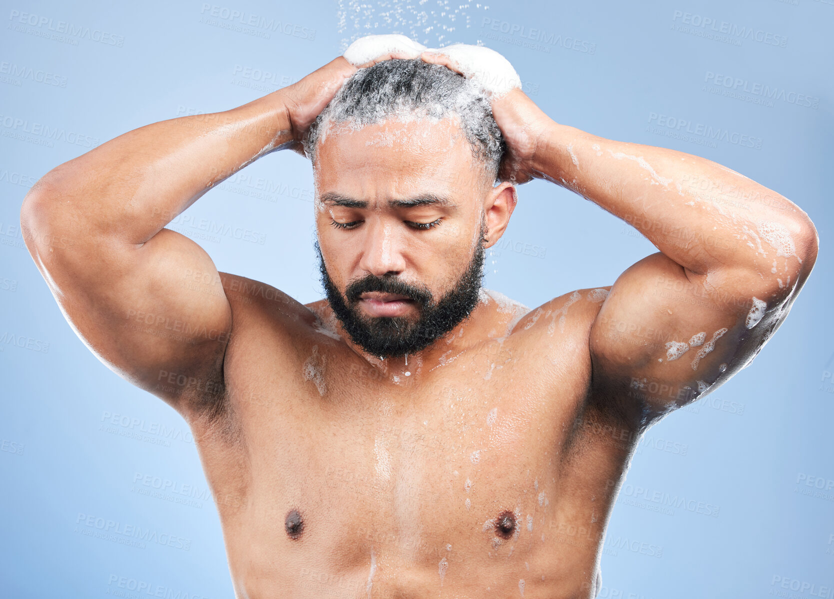 Buy stock photo Shower, washing hair and man with water in studio for cleaning, hygiene and skincare on blue background. Dermatology, bathroom and person with shampoo, foam and grooming for wellness and health