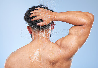 Buy stock photo Man, shower back and hair care in studio with water splash, hygiene or muscle by blue background. Person, guy and cleaning with drop, wellness and health for skin, natural and dermatology for body