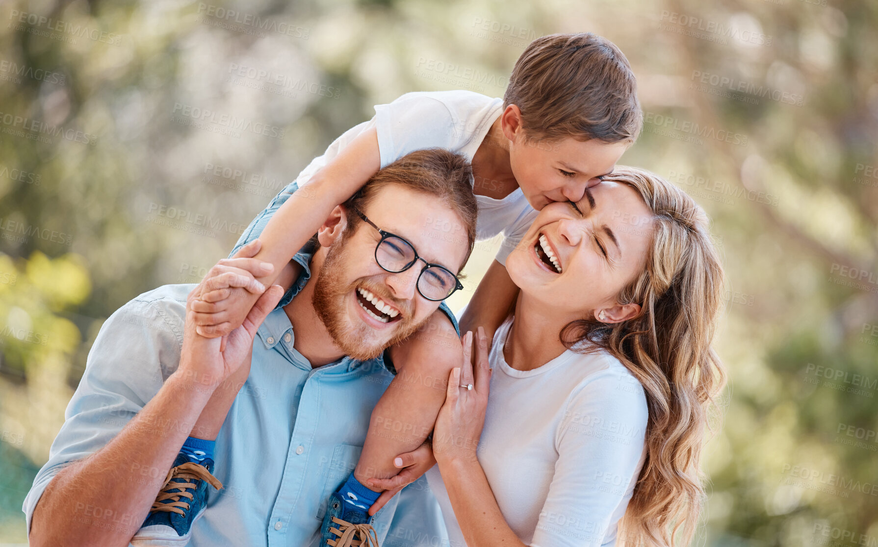 Buy stock photo Nature, smile and child with parents in a garden bonding together on a summer weekend trip. Happy, love and young boy kid kissing his mother on his father shoulders in an outdoor park or field.