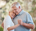 Love, dance and smile with a senior couple outdoor together for romance or bonding in retirement. Summer, nature or park with a happy elderly man and woman in their garden or backyard for marriage