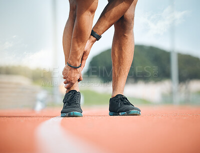 Buy stock photo Fitness, running and ankle pain with a sports person holding their leg closeup on a race track outdoor. Exercise, training and the legs of an athlete with a joint injury at a stadium or venue