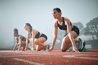 Buy stock photo Women, runner and race track start block for marathon competition, training or ready. Female people, line for speed test on field for group challenge or fast cardio professional, arena as fit athlete