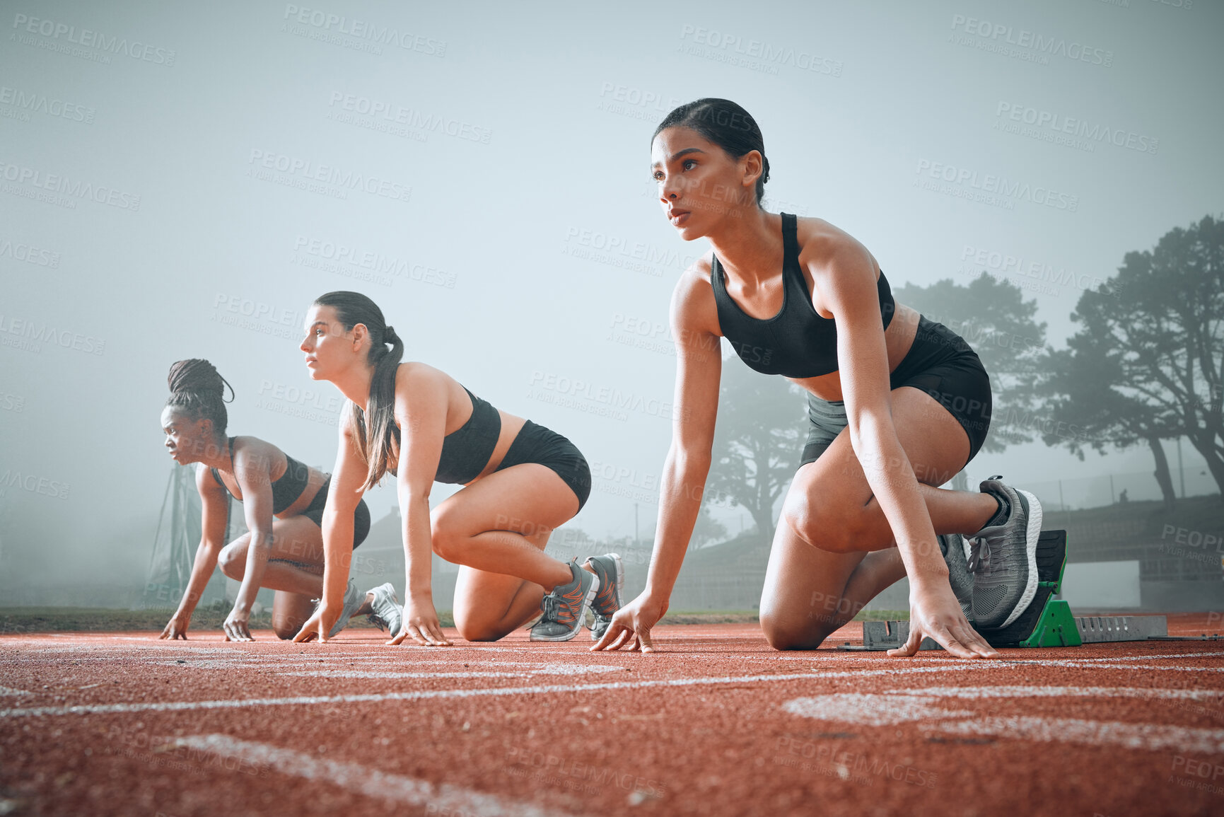 Buy stock photo Women, runner and race track start block for marathon competition, training or ready. Female people, line for speed test on field for group challenge or fast cardio professional, arena as fit athlete