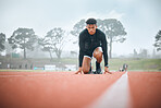 Running, track and man in stadium for marathon training, exercise and cardio workout outdoors. Fitness, sports and runner getting ready to start for performance, race event and challenge in arena