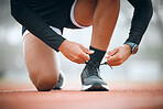 Running, track and runner tie shoes in stadium for marathon training, exercise and cardio workout. Fitness, sports and closeup of person tying sneaker laces for performance, race event and challenge